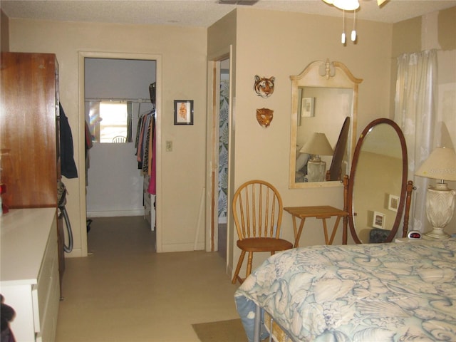 bedroom featuring a spacious closet and a closet