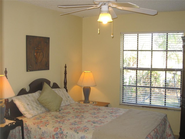 bedroom with multiple windows and ceiling fan