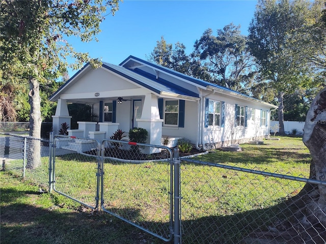 ranch-style house featuring covered porch and a front yard