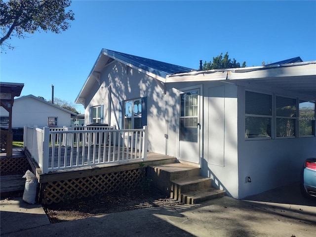 rear view of house featuring a deck