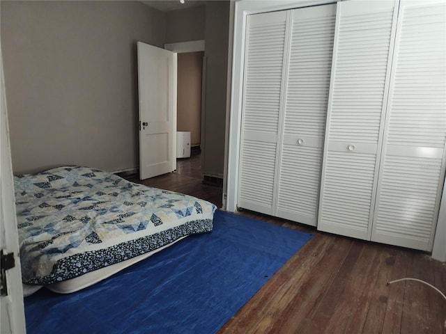 bedroom featuring dark hardwood / wood-style flooring and a closet