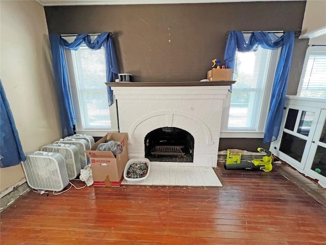 14124 Plum Ln, Hudson, FL 34667 - living room featuring hardwood / wood-style floors, healthy amount of natural light, and a fireplace