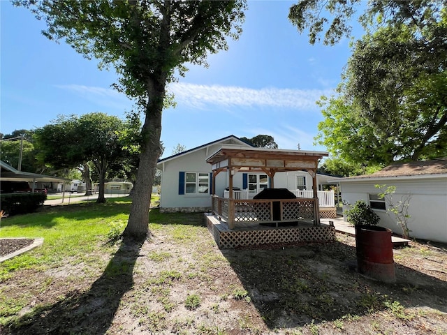 14124 Plum Ln, Hudson, FL 34667 - rear view of property featuring a gazebo, a deck, and a yard