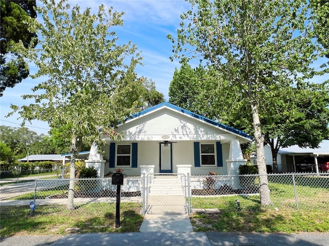 14124 Plum Ln, Hudson, FL 34667 - view of front of home featuring covered porch, a gate, a fenced front yard, and stucco siding