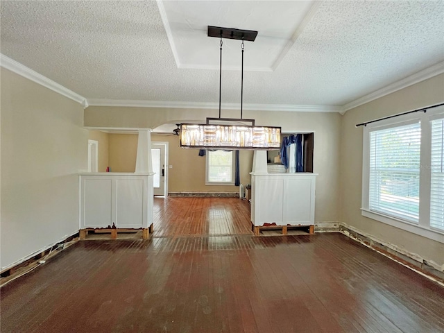 14124 Plum Ln, Hudson, FL 34667 - unfurnished dining area featuring wood-type flooring, a textured ceiling, and ornamental molding
