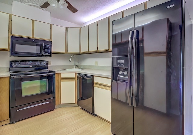 kitchen featuring sink, a textured ceiling, ceiling fan, light hardwood / wood-style floors, and black appliances