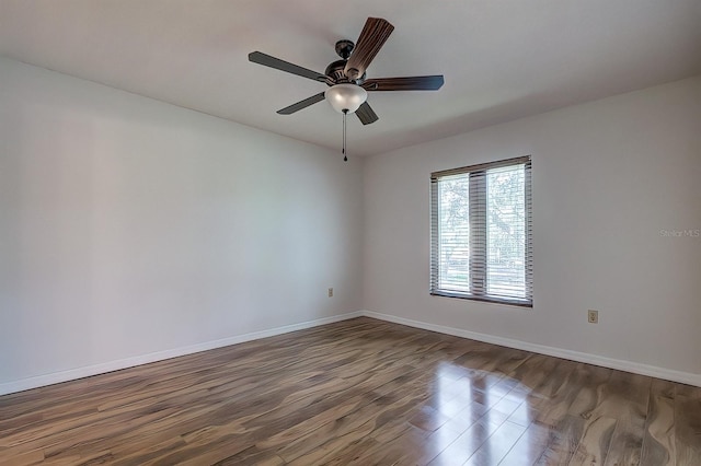 empty room with ceiling fan and hardwood / wood-style floors