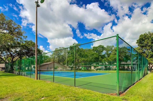 view of sport court with a yard