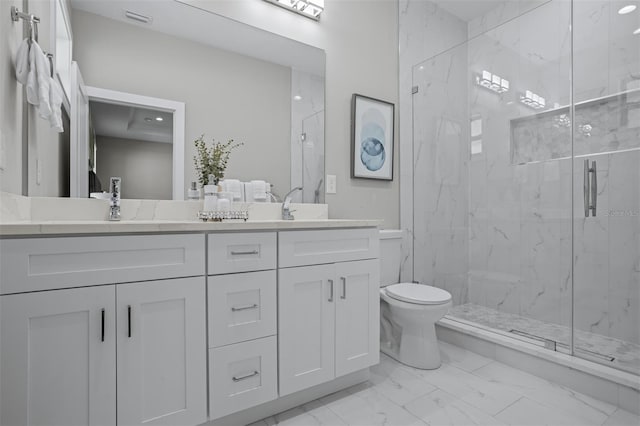 bathroom featuring vanity, toilet, and a shower with shower door