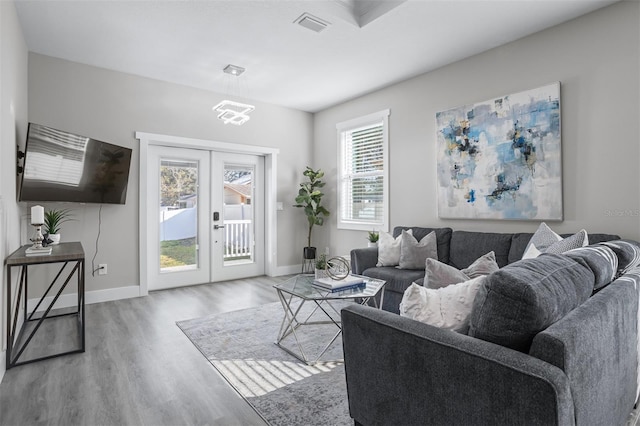 living room with french doors and hardwood / wood-style floors