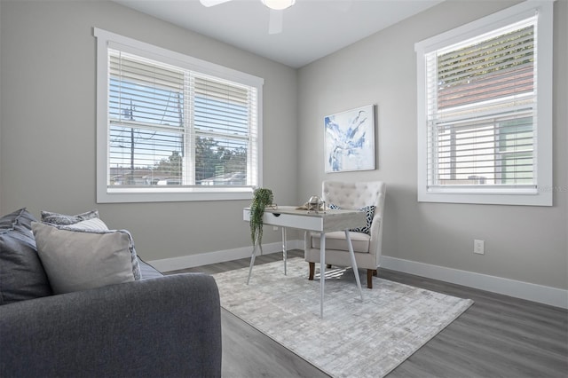 office space with dark wood-type flooring and ceiling fan