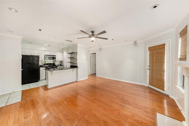 unfurnished living room with ornamental molding, ceiling fan, and light wood-type flooring