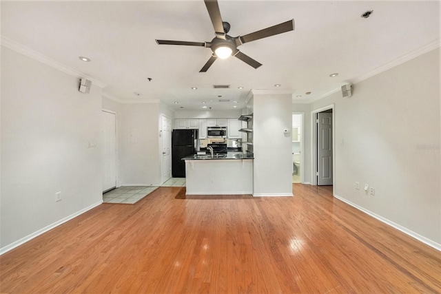 unfurnished living room with sink, crown molding, light hardwood / wood-style floors, and ceiling fan