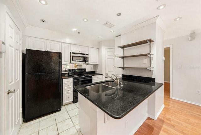 kitchen with sink, a breakfast bar area, black appliances, kitchen peninsula, and white cabinets