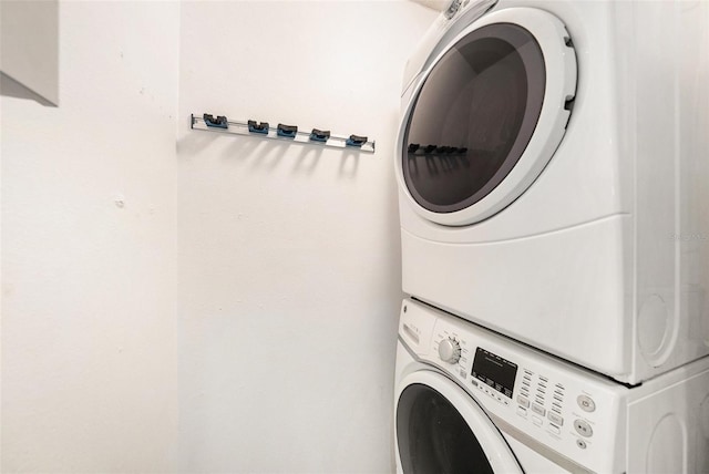 clothes washing area featuring stacked washer / dryer