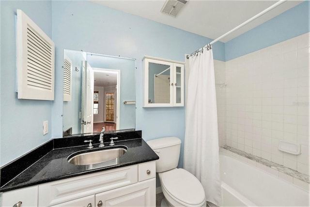 full bathroom featuring vanity, shower / bath combination with curtain, and toilet