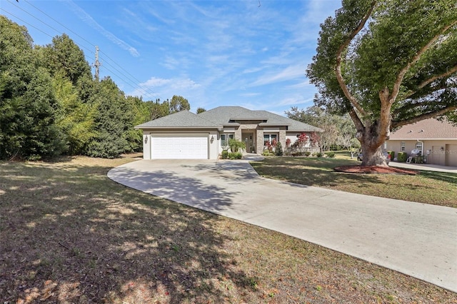 view of front facade with a garage and a front yard