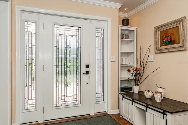 foyer featuring baseboards and ornamental molding