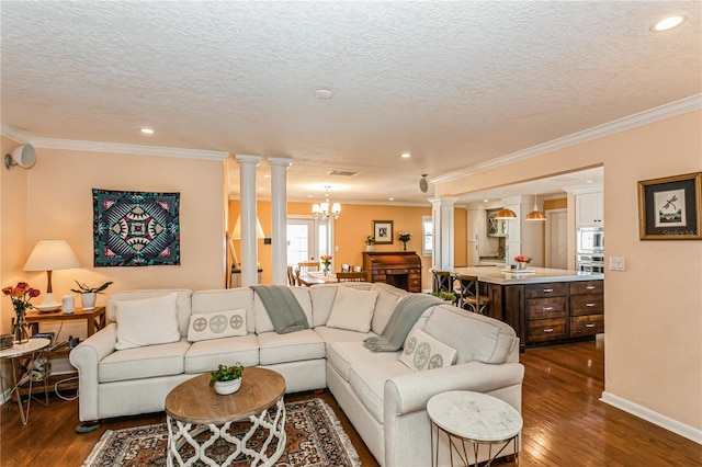 living area with ornamental molding, dark wood-style flooring, and ornate columns