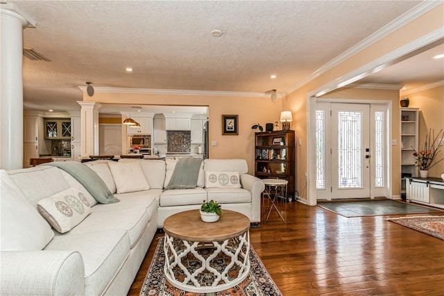 living room featuring dark wood-style flooring, decorative columns, ornamental molding, a textured ceiling, and baseboards