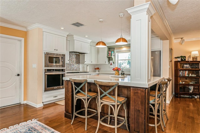 kitchen with ornamental molding, stainless steel appliances, open shelves, and light countertops