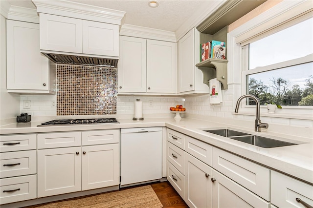 kitchen with dishwasher, light countertops, open shelves, and a sink