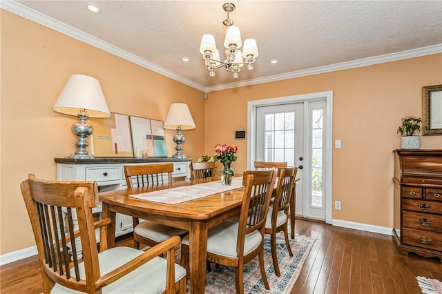 dining room featuring a textured ceiling, baseboards, dark wood-style flooring, and ornamental molding