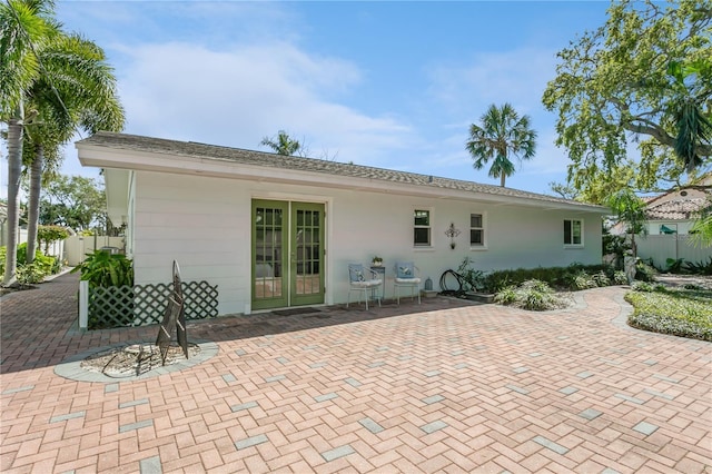 back of property with a patio and fence