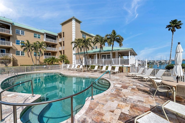 pool with fence and a patio