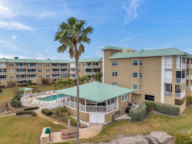 view of building exterior featuring a community pool