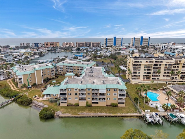 birds eye view of property with a water view and a view of city