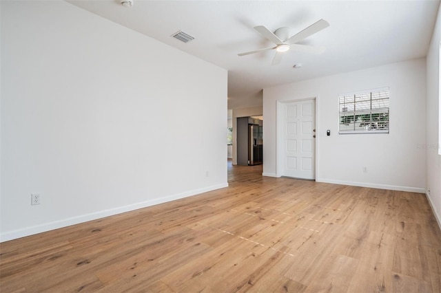 empty room with ceiling fan and light hardwood / wood-style floors