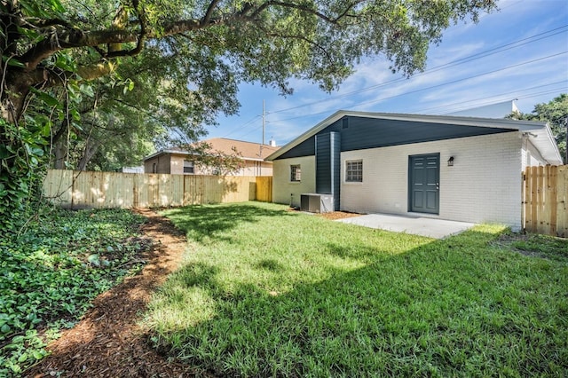 view of yard featuring a patio and central AC