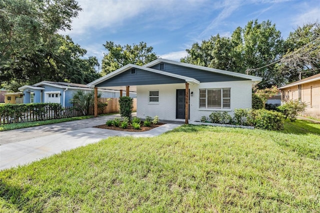 ranch-style home featuring a front yard and a carport