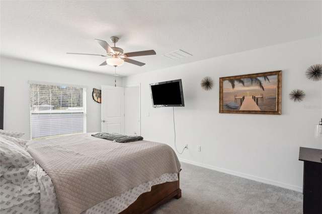 bedroom with visible vents, baseboards, carpet, and a ceiling fan