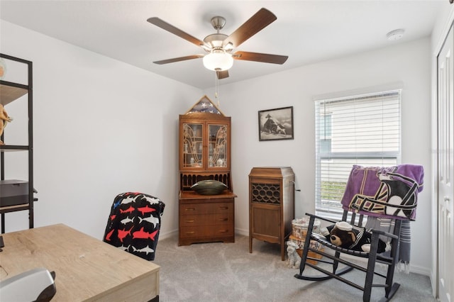 home office with light carpet and ceiling fan