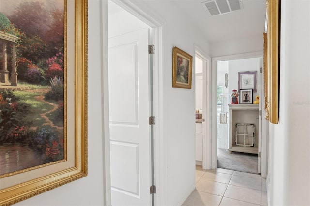 hallway with light tile patterned floors and visible vents