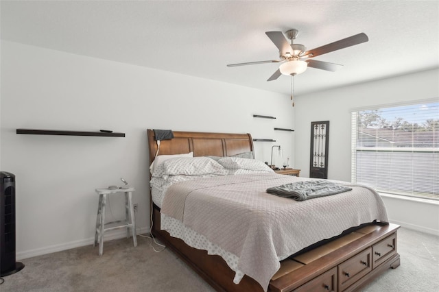 bedroom with baseboards, light carpet, and ceiling fan