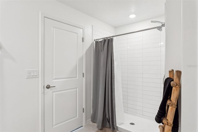 full bathroom with tile patterned floors and a stall shower