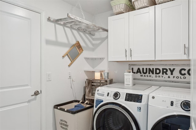 laundry area with washer and dryer and cabinet space