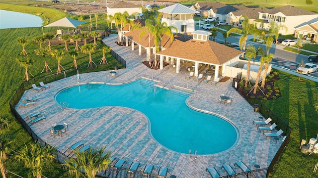 pool featuring a residential view, a patio, and fence