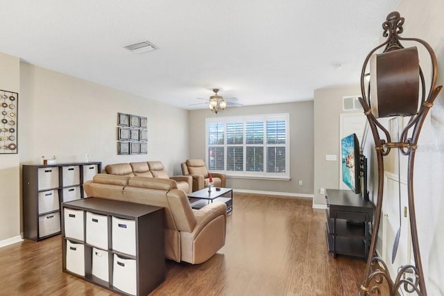 living room with wood-type flooring and ceiling fan