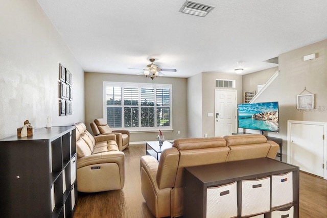 living room with ceiling fan and dark hardwood / wood-style floors