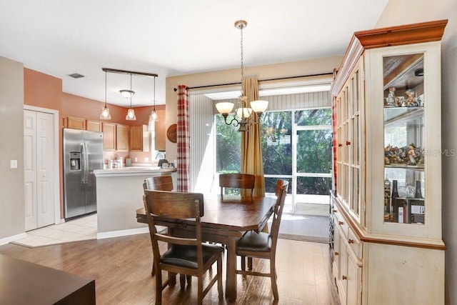 dining space featuring a chandelier and light wood-type flooring