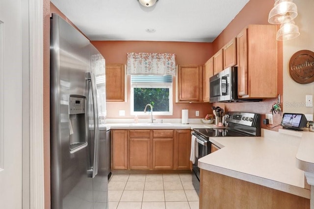 kitchen featuring pendant lighting, sink, light tile patterned flooring, and appliances with stainless steel finishes