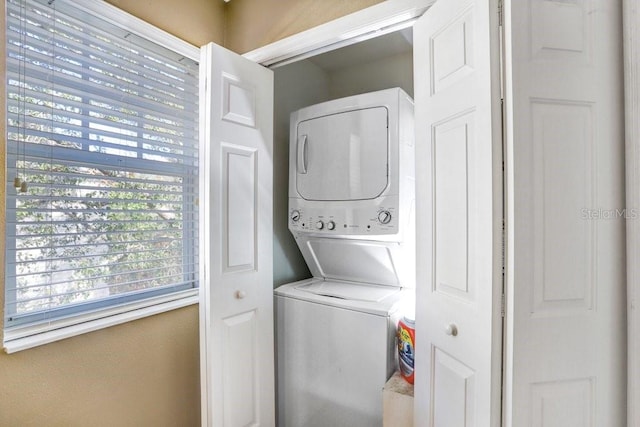 washroom with stacked washer / drying machine