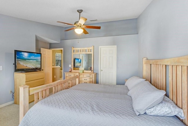 bedroom with vaulted ceiling, light colored carpet, and ceiling fan