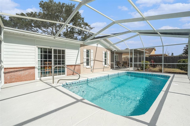 view of swimming pool with a patio area and glass enclosure