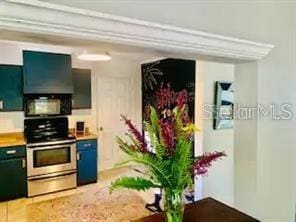 kitchen featuring stainless steel electric range oven and wall chimney range hood