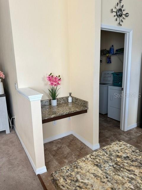 interior space with baseboards and independent washer and dryer